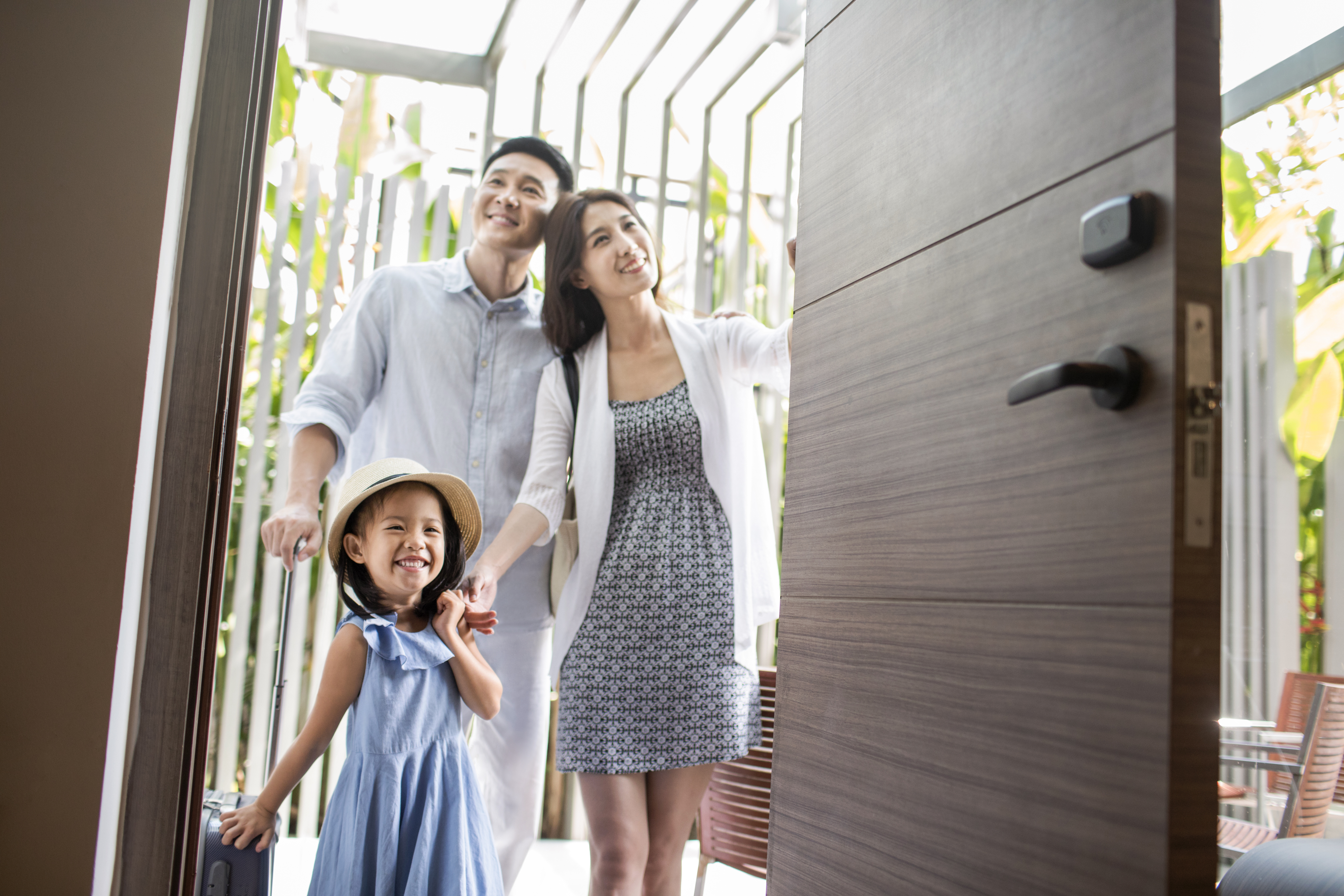 Family standing at the door of their home